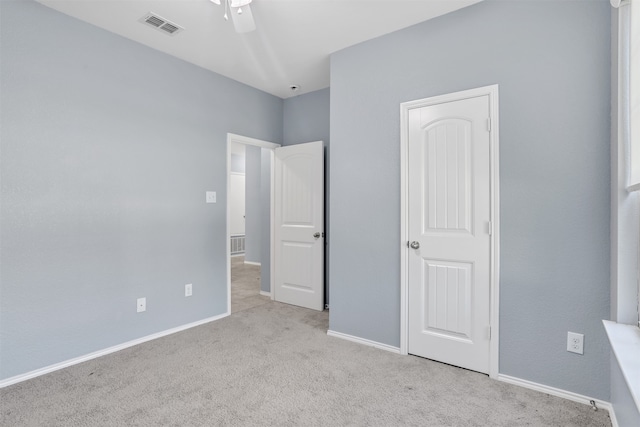 unfurnished bedroom featuring ceiling fan and light colored carpet