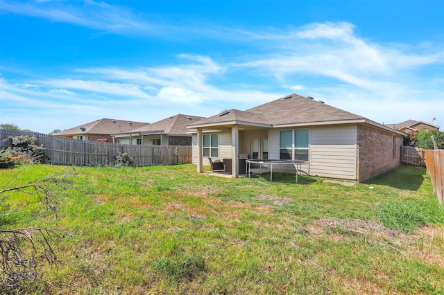 back of house featuring a yard