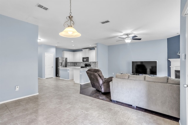 living room featuring light tile patterned floors and ceiling fan