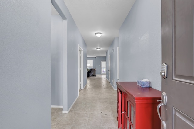 hallway with light tile patterned floors