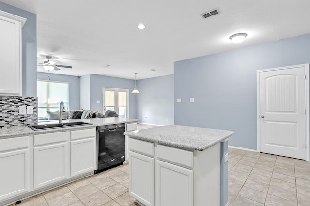 kitchen with black dishwasher, sink, and white cabinets