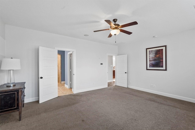 unfurnished bedroom with ceiling fan and light carpet