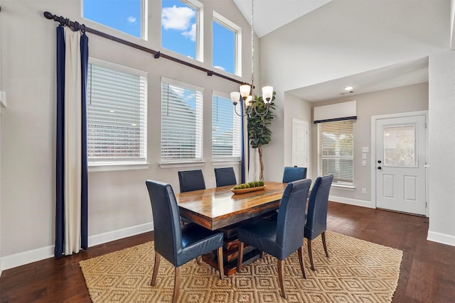 dining area with high vaulted ceiling and dark hardwood / wood-style flooring