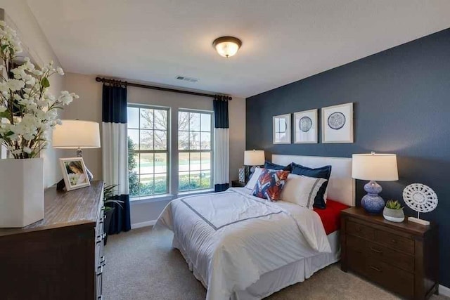 bedroom featuring light colored carpet