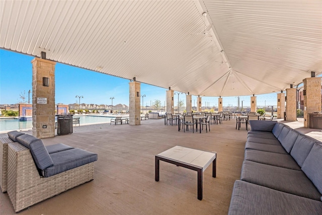 view of patio featuring a water view and a community pool