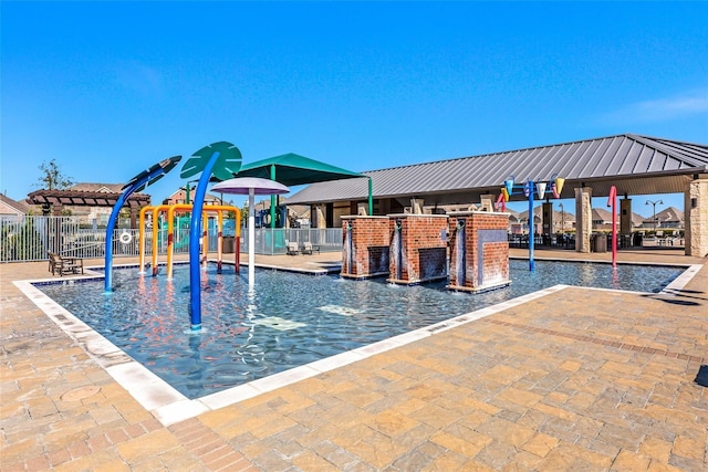 view of swimming pool featuring pool water feature and an outdoor bar