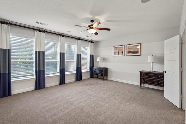 unfurnished bedroom featuring ceiling fan and carpet