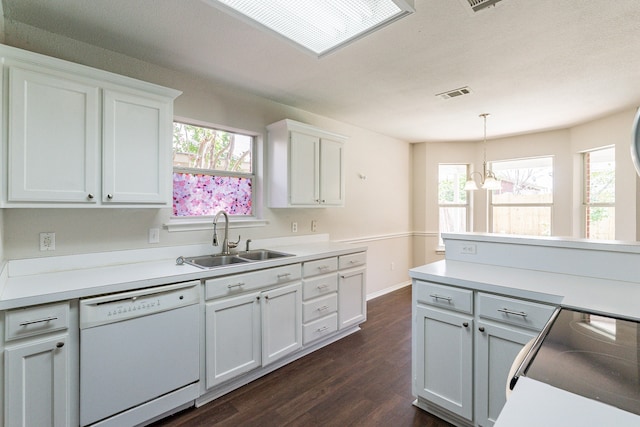 kitchen featuring dark wood-type flooring, white dishwasher, a wealth of natural light, and pendant lighting