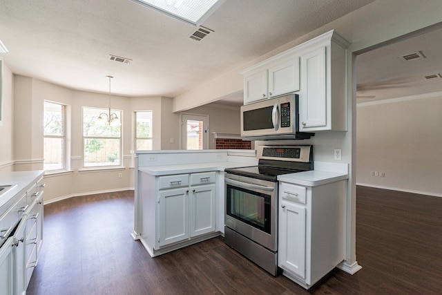 kitchen featuring stainless steel appliances, white cabinets, pendant lighting, kitchen peninsula, and dark wood-type flooring