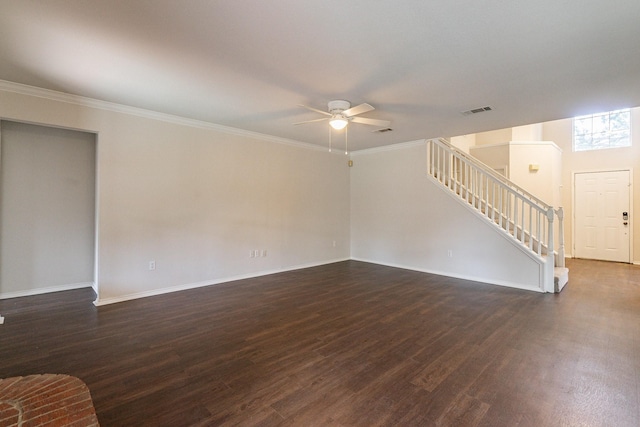 unfurnished living room featuring dark wood-type flooring, ornamental molding, and ceiling fan