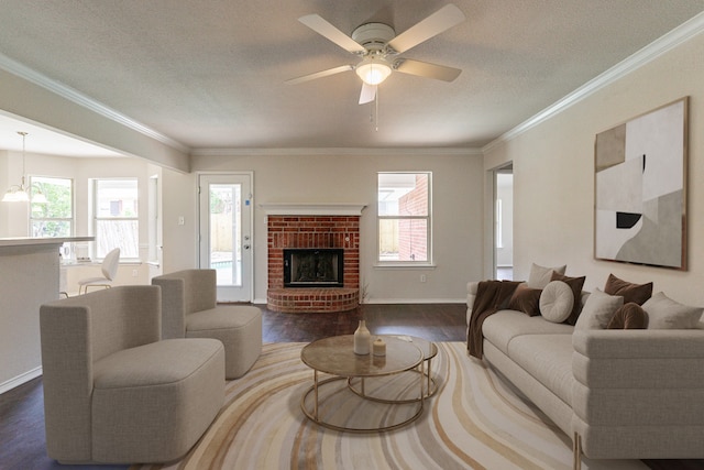 living room featuring a fireplace, a wealth of natural light, crown molding, and hardwood / wood-style floors