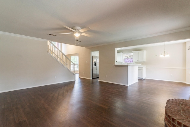 unfurnished living room with dark wood-type flooring, crown molding, and ceiling fan with notable chandelier