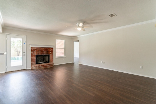 unfurnished living room featuring dark hardwood / wood-style flooring, ceiling fan, a fireplace, and a healthy amount of sunlight