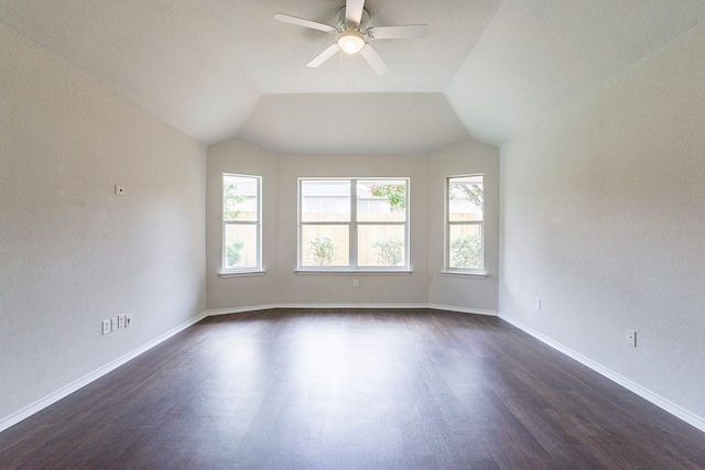 empty room featuring dark hardwood / wood-style floors, ceiling fan, and lofted ceiling