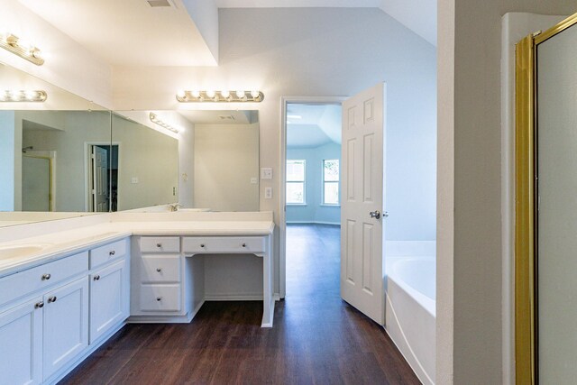 bathroom featuring hardwood / wood-style floors, separate shower and tub, vaulted ceiling, and double sink vanity