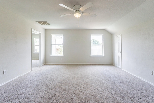 unfurnished room featuring light carpet, plenty of natural light, and ceiling fan