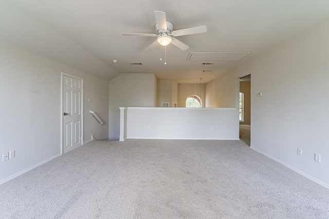 empty room with carpet flooring, lofted ceiling, and ceiling fan