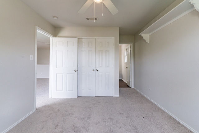 spare room featuring ceiling fan, vaulted ceiling, and light colored carpet