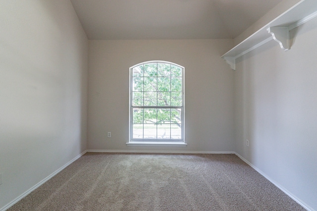 carpeted empty room featuring lofted ceiling and ceiling fan