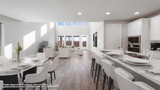 dining space with sink and hardwood / wood-style flooring