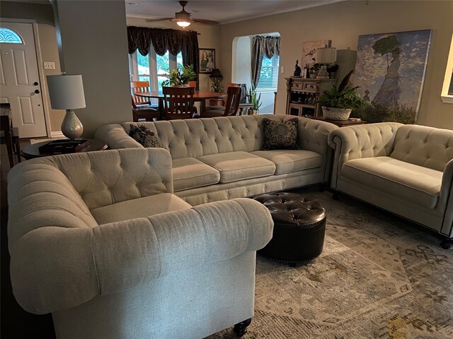 living room with ceiling fan and ornamental molding