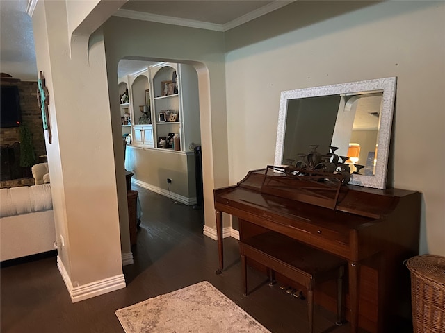 misc room featuring dark wood-type flooring, built in features, and ornamental molding