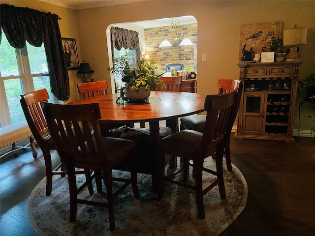 dining room featuring hardwood / wood-style flooring, a notable chandelier, and ornamental molding