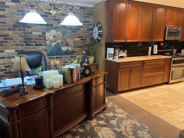 kitchen featuring light hardwood / wood-style flooring, backsplash, stainless steel appliances, hanging light fixtures, and brick wall