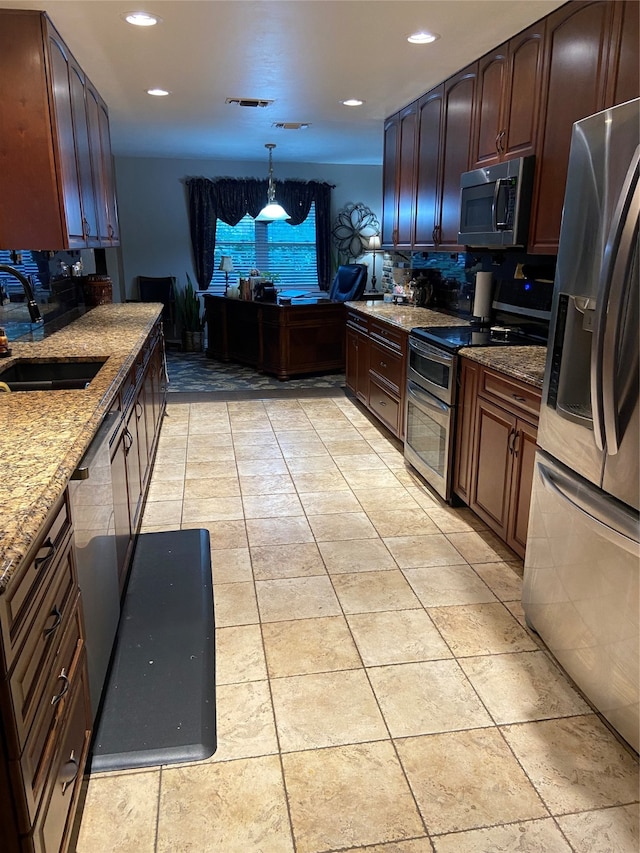 kitchen featuring sink, appliances with stainless steel finishes, decorative light fixtures, and light tile patterned floors