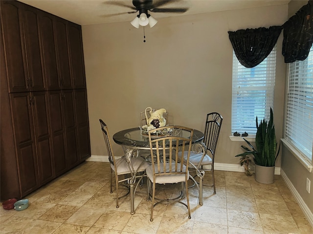 dining space featuring light tile patterned floors and ceiling fan