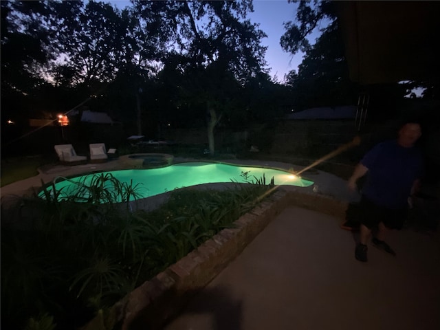 view of pool at dusk