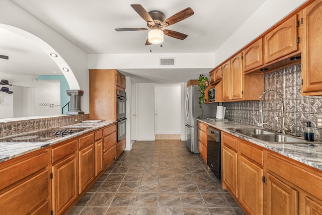 kitchen featuring tasteful backsplash, sink, black appliances, and dark tile patterned floors