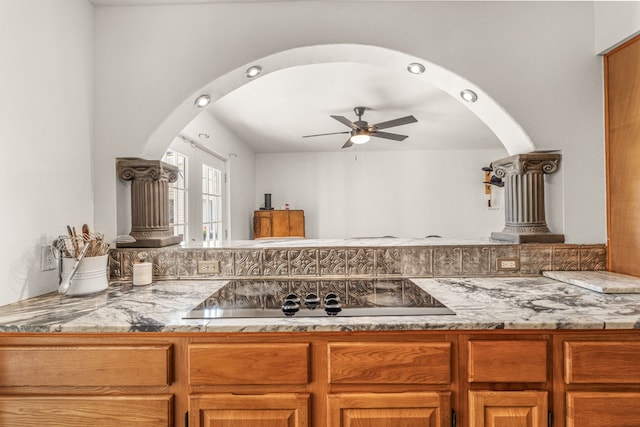 kitchen with black electric stovetop, ceiling fan, and decorative backsplash