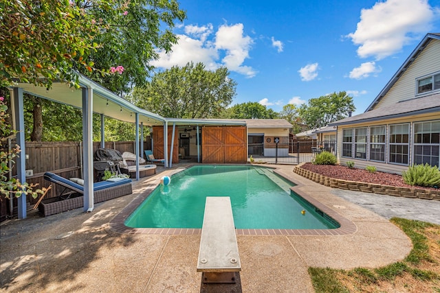 view of pool featuring a patio and a diving board