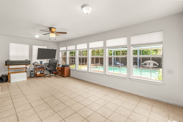 interior space with ceiling fan, light tile patterned flooring, and a healthy amount of sunlight