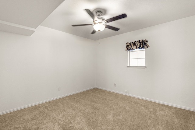 carpeted empty room featuring ceiling fan