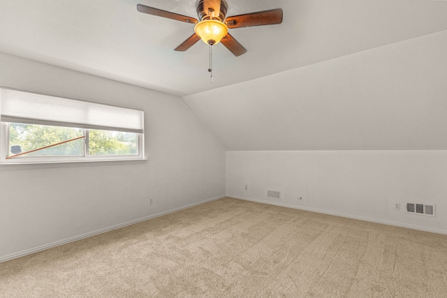 bonus room with ceiling fan, vaulted ceiling, and light colored carpet