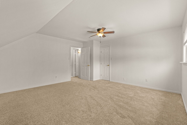 carpeted empty room featuring lofted ceiling and ceiling fan