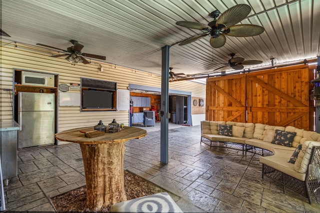 view of patio featuring ceiling fan and an outdoor living space