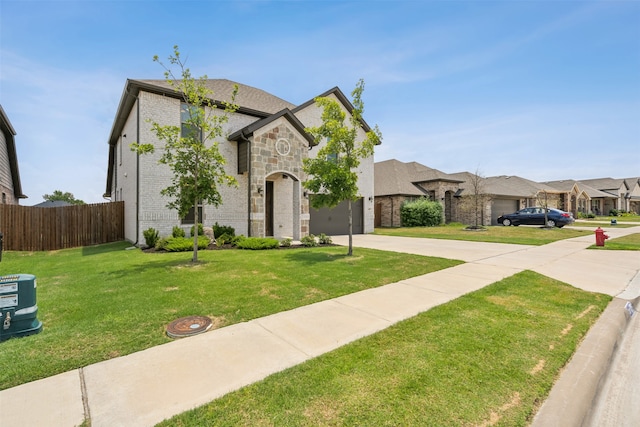 french provincial home with a garage and a front yard