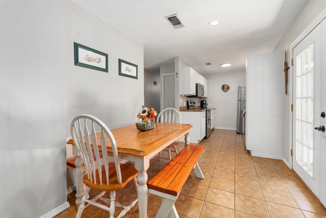 tiled dining area featuring french doors and plenty of natural light