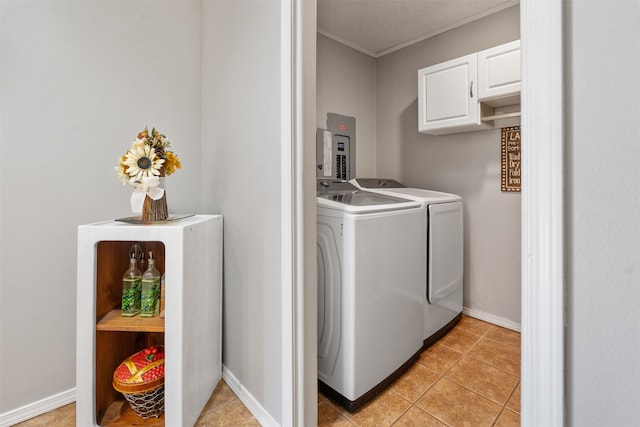 washroom with ornamental molding, washing machine and dryer, and light tile patterned floors