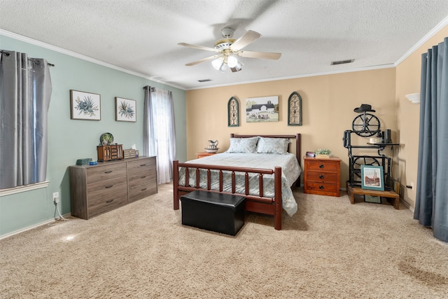 bedroom with a textured ceiling, carpet, ornamental molding, and ceiling fan