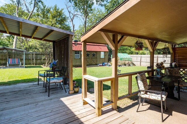 wooden deck featuring a trampoline and a lawn