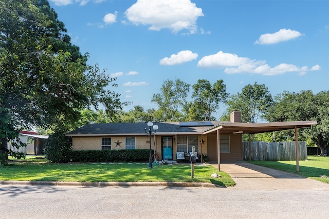 ranch-style home featuring a carport and a front yard