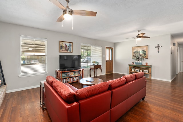 living room featuring a textured ceiling, ceiling fan, and dark hardwood / wood-style floors