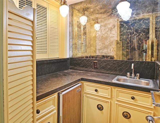 kitchen featuring decorative light fixtures, sink, and backsplash