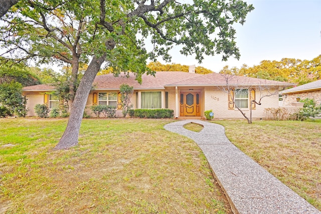 ranch-style home with a front lawn