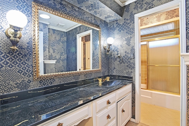 bathroom with ornamental molding, vanity, and shower / bath combination with glass door