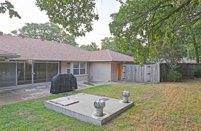 exterior space with a lawn and a patio